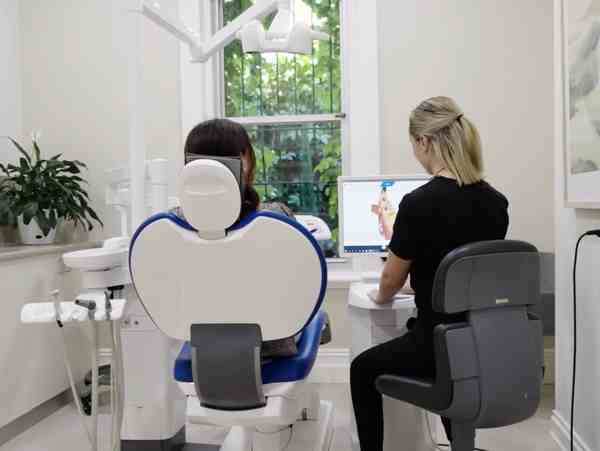 Patient receiving gentle care from a Glenelg dentist at a modern clinic; professional dentists providing quality treatment in Glenelg.