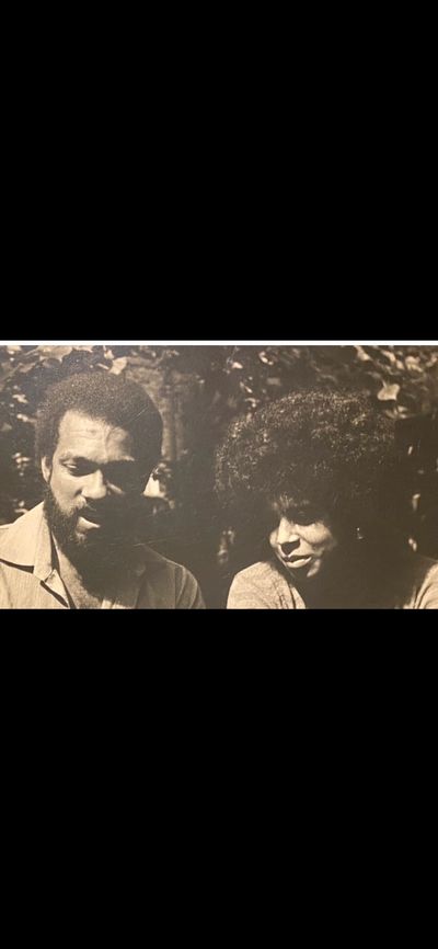 Vintage black and white photo of a man and woman with natural hairstyles.