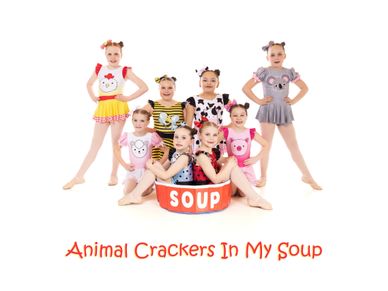 Young girls in animal-themed costumes posing with a soup bowl prop.