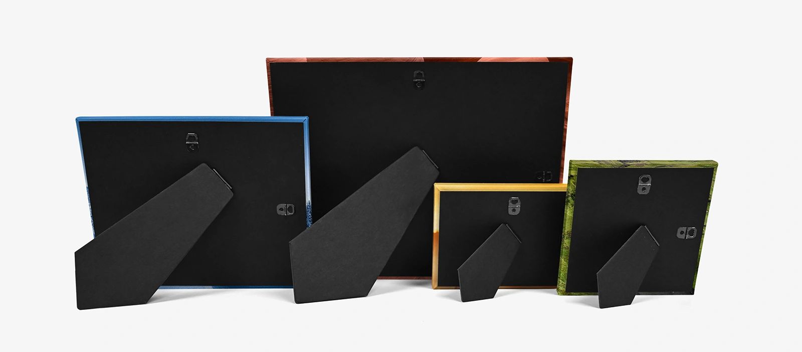 Four picture frames of different sizes shown from the back on a white background.