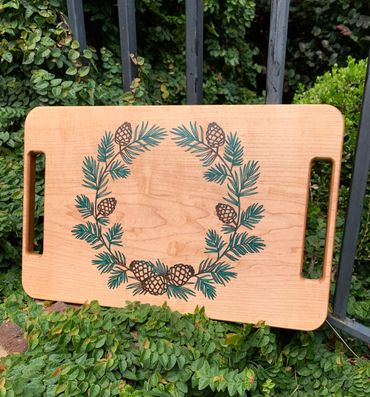 Maple serving tray.  Pine cone design with pine needles done in green and brown epoxy resin