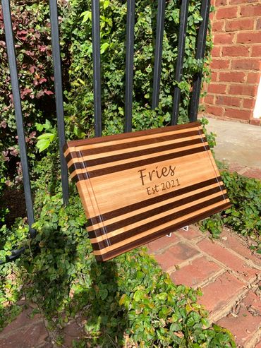 Wedding gift  - walnut and maple long grain cutting board engraved with the couple's name and year