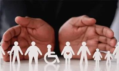 Hands protect paper cutouts representing diverse people, including disabled and pregnant individuals.