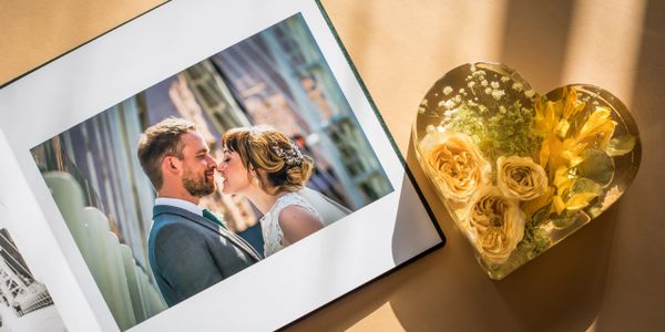 Wedding photo album and resin heart-shaped block with preserved flowers