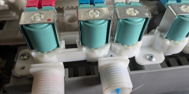 Close-up of solenoid valves in a mechanical system.