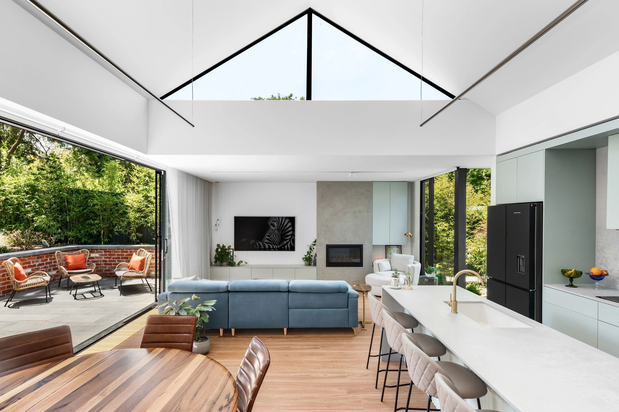 Bright modern living space with large windows and open patio area.
