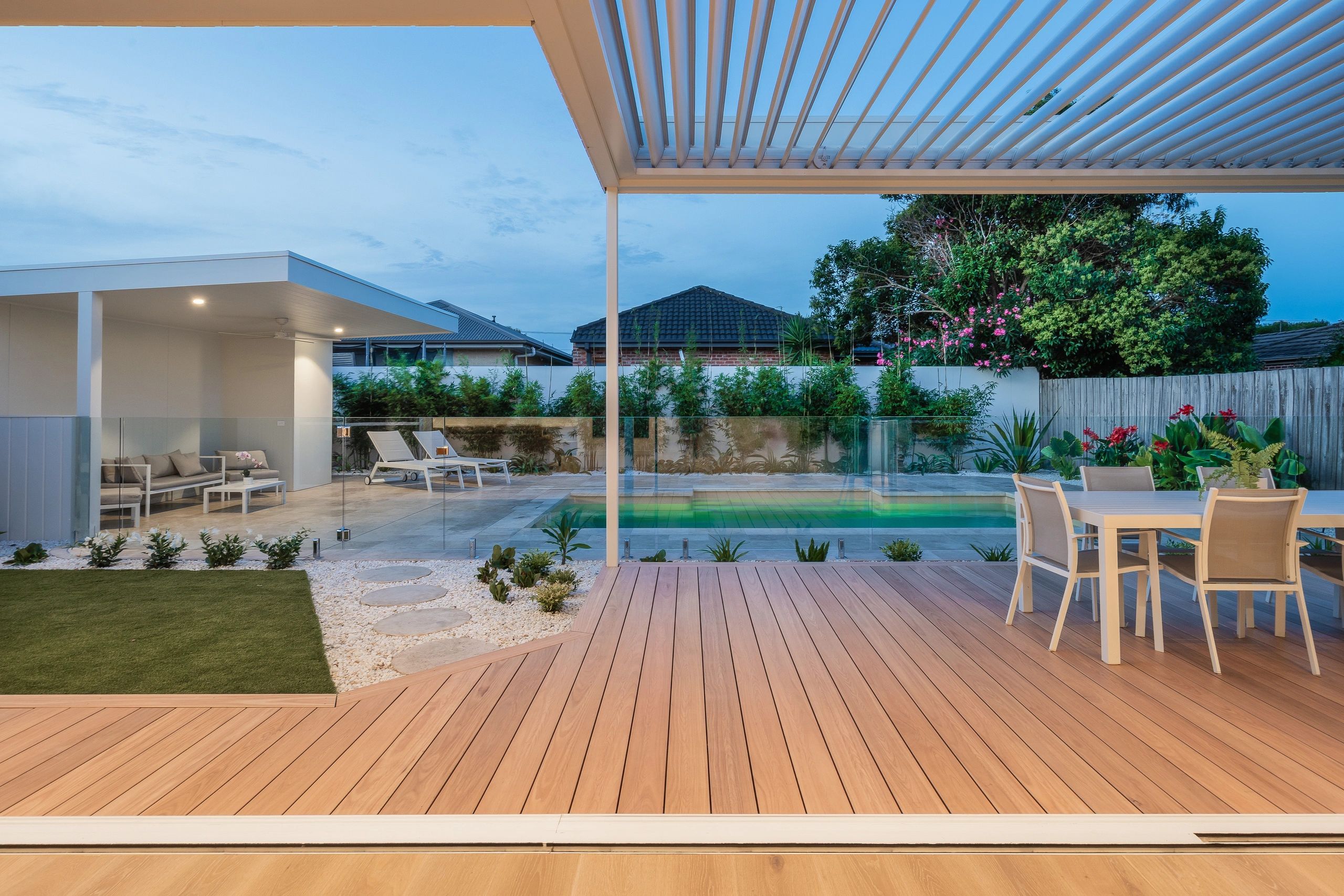 Modern backyard with pool, patio, and seating area.