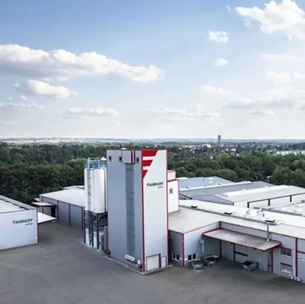 A large industrial building with the name YANSHOFF under a blue sky.