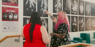 Image of 2 women pointing at an exhibition. 