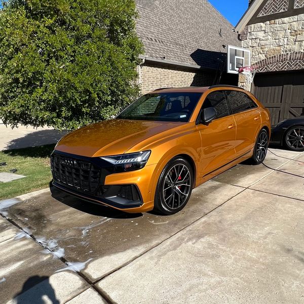 Dark orange Audi SUV in driveway.