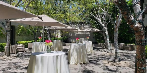 High top tables with flower arrangements at a beautiful venue 