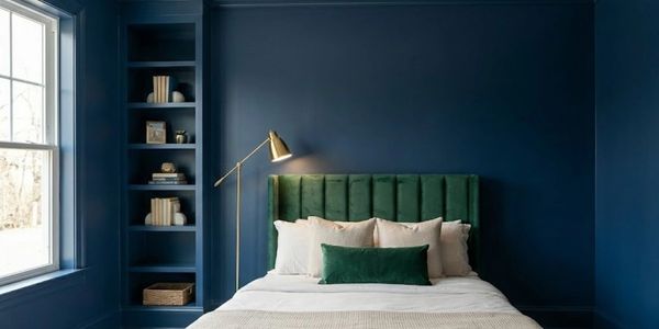 Bedroom with deep blue accent wall, home improvement