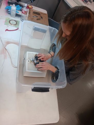 Student using the glass grinder on a project during a stained glass private lesson.