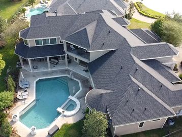 A large house with a pool and patio area.