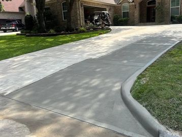 Newly poured concrete driveway in front of a home.