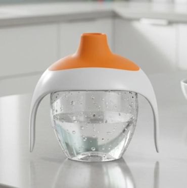 Modern water filter pitcher with orange lid on kitchen counter.