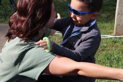 Donna hugs a child at the OOTD Walk to Prevent Suicide with  Embrace the World, 2017 photo by J Geis