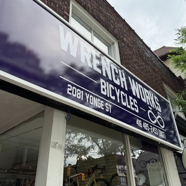 Sign for Wrench Works Bicycles at 2081 Yonge Street.
