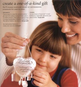 a mother and daughter holding a heart wind chime 