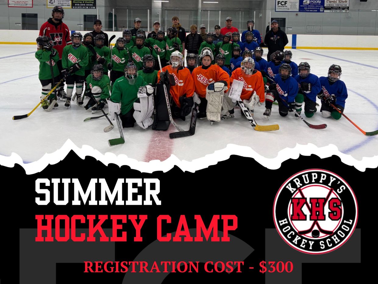Youth hockey players and coaches pose on ice for summer camp.