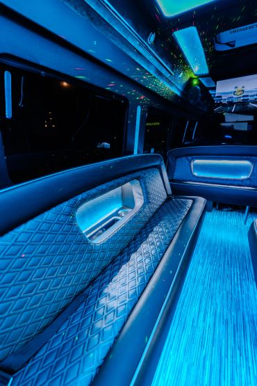 Interior of a luxury vehicle with blue LED lighting and quilted leather seating.