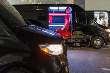 Black Sprinter vans with one interior illuminated in red lighting.
