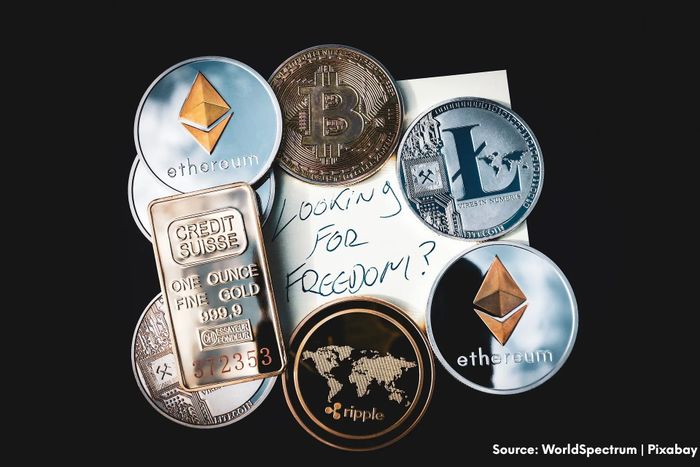 Various cryptocurrency coins and a gold bar over a note saying 'Looking for freedom?'