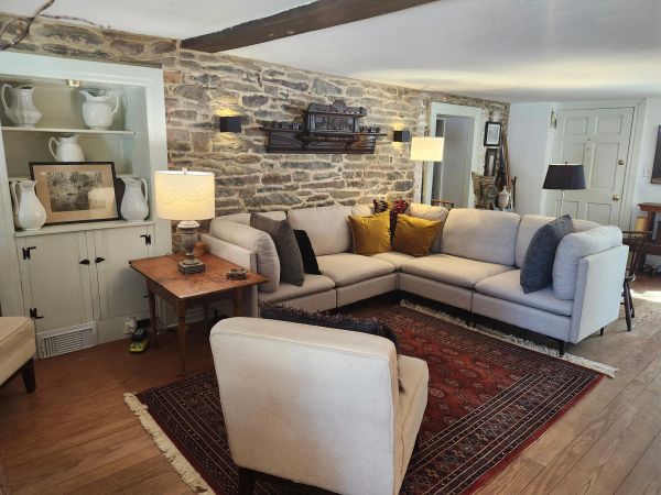Cozy living room with stone wall and sectional sofa.