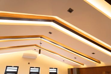 Modern ceiling with recessed lighting and wood accents.
