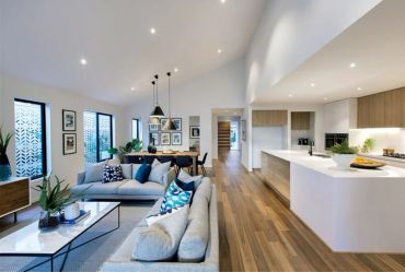 Spacious modern open-plan living room and kitchen with wooden floors.