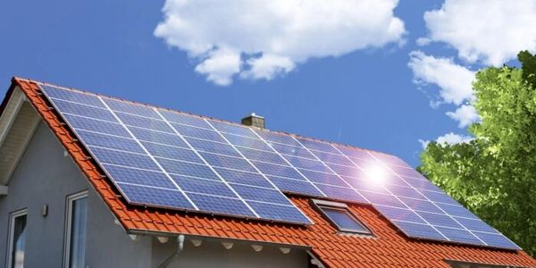 Photograph showing installation of Solar Panels on Roof of Property.  