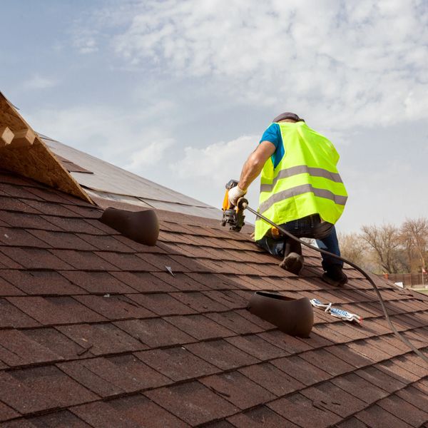 A professional repairing a roof