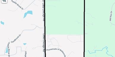 Map showing a road and nearby residential areas with green spaces.