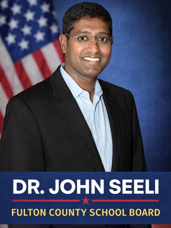 Dr. John Seeli, candidate for Fulton County School Board, posing with an American flag.