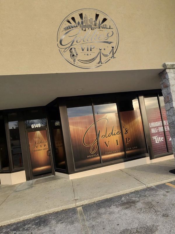 Front view of Goldie's VIP with branded windows and logo above.