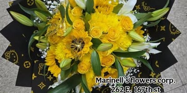 Bouquet of yellow flowers with green leaves.