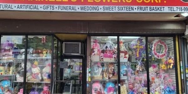 Flower shop window filled with colorful arrangements and gifts.