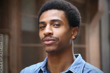Confident young man with a slight smile.