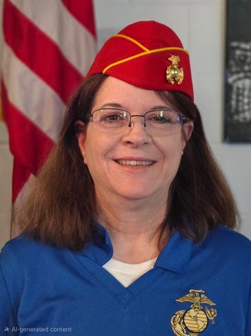Woman in Marine Corps uniform with red hat and glasses.