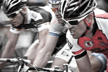 Cyclists fiercely competing in a high-speed race moment.