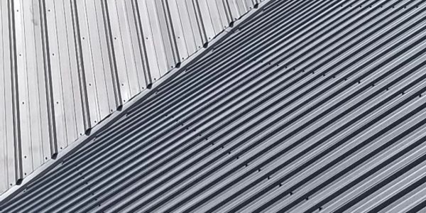 Close-up of two different metal corrugated sheets overlapping.