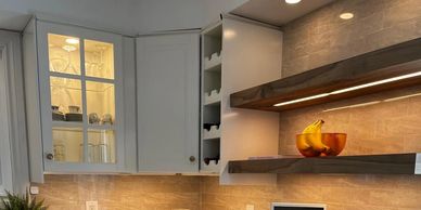Cozy modern kitchen corner with white cabinets and warm lighting.