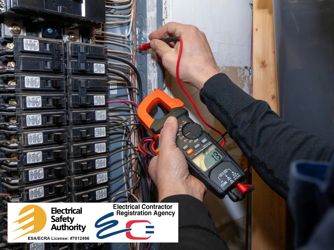 Electrician testing electrical panel with multimeter for safety.