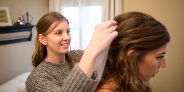 Bridal appointment helping bride with veil.