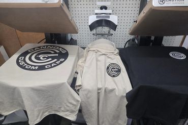 Three Cannon Custom Caps t-shirts displayed.