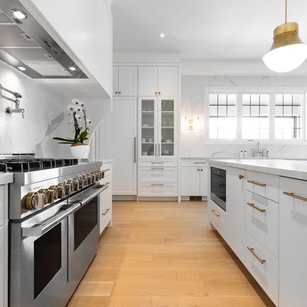 White country kitchen with shaker cabinets and 60” gas Viking range with gold hardware in Linwood NJ