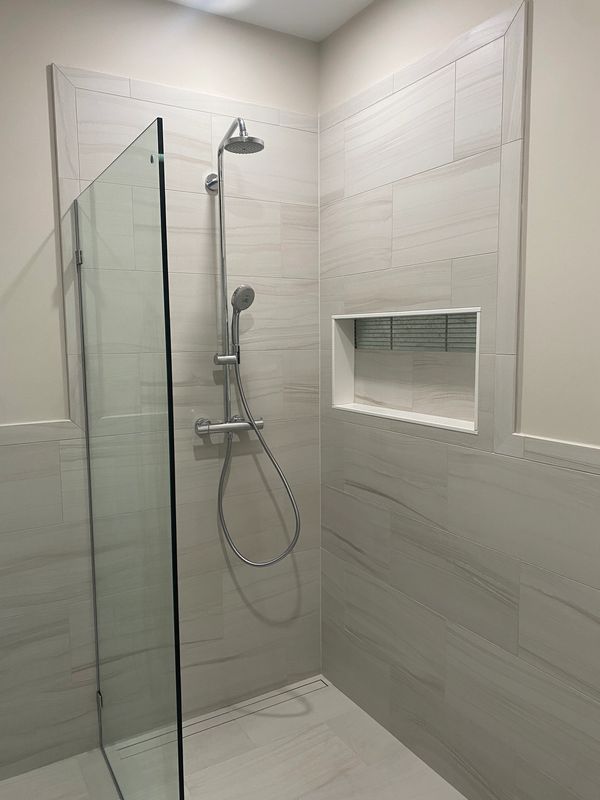 abba construction group Hansgrohe raindajnce shower pipe in chrome with Florida 12 x24 bliss tiles