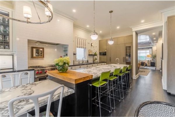 modern galley kitchen with island of black base cabinets and marble counter top in stone harbor nj