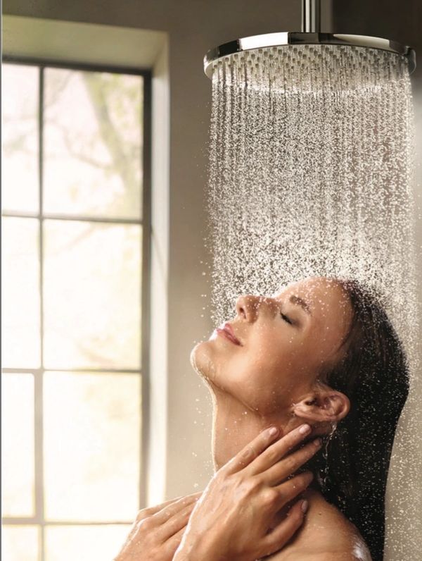abba construction group Hansgrohe raindance ceiling shower head  with woman standing under shower 