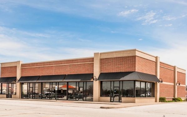 ABBA Construction Group retail plaza finished in rad brick and beige brick with black windows